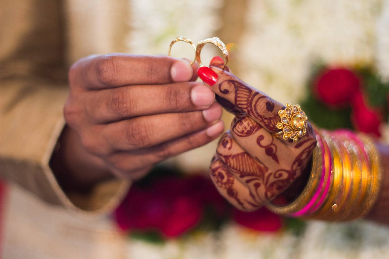 Indian Couple Enthralling Moment Of Exchanging Wedding Rings Wallpaper