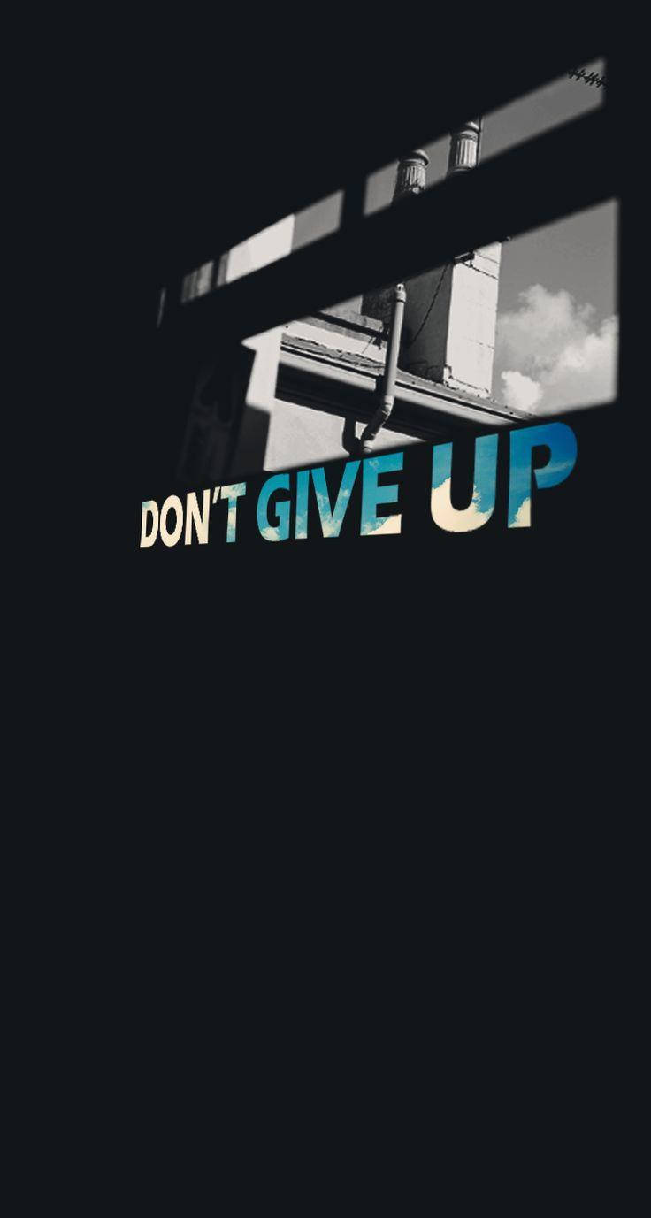 Inspiring Sky View With 'never Give Up' Message Wallpaper