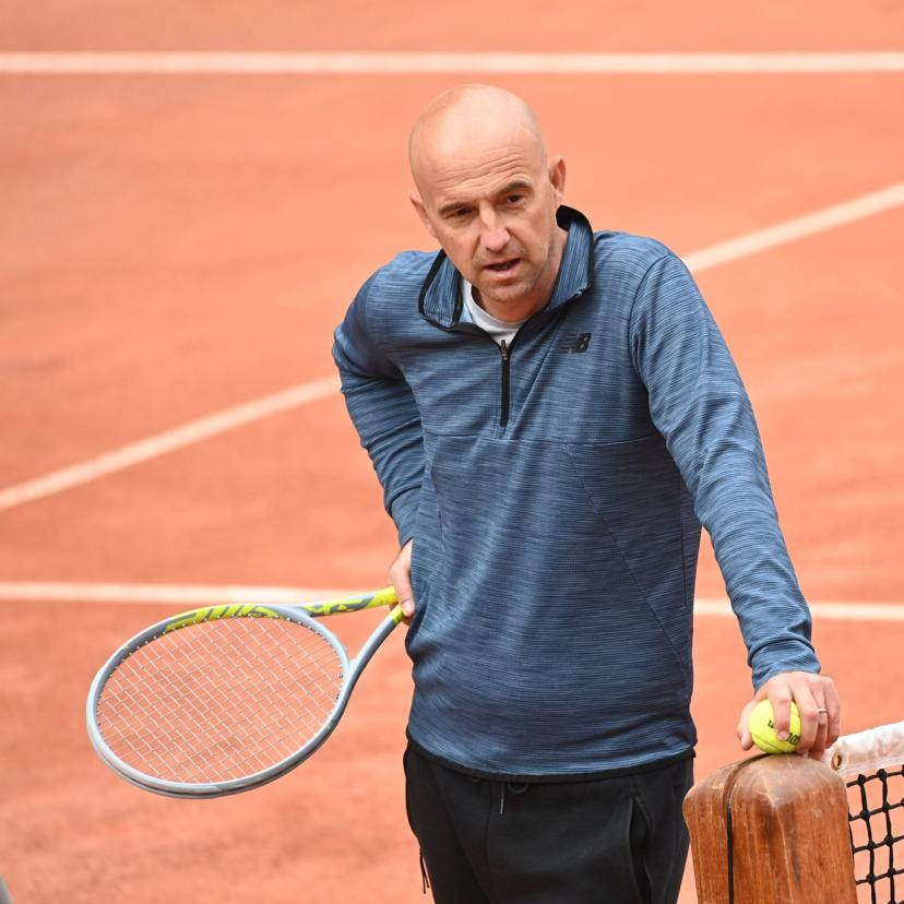 Ivan Ljubicic Intensely Leaning On Tennis Net Wallpaper