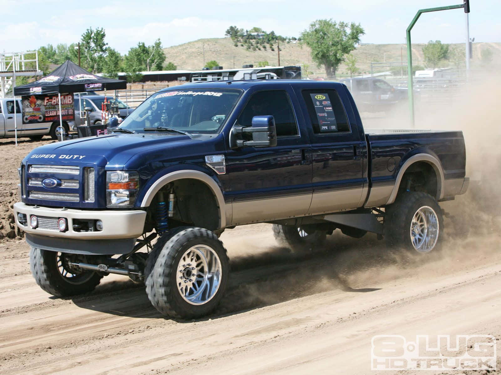 Jacked Up Trucks Creating A Dusty Trail Wallpaper