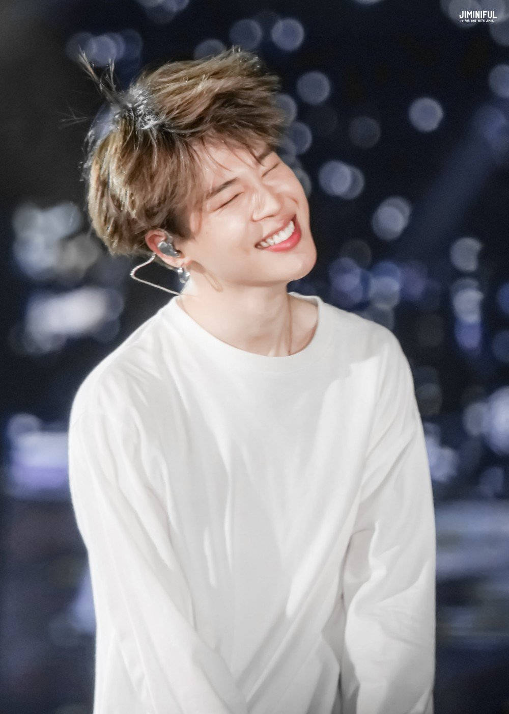 Jimin Of Bts Smiles At His Fans Onstage Wallpaper