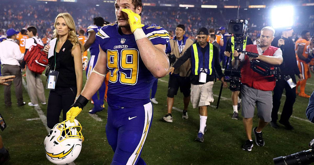 Joey Bosa Fiercely Fighting On The Football Field Wallpaper