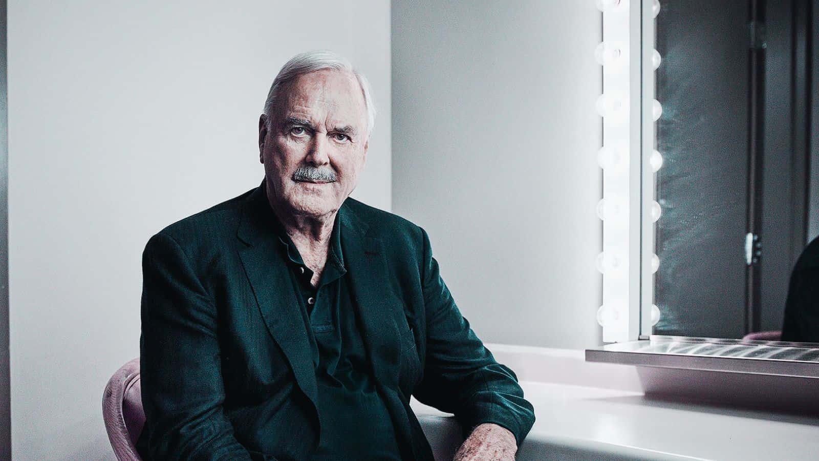 John Cleese Engaging In A Candid Moment Wallpaper