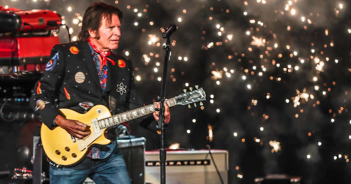 John Fogerty Performing Livewith Fireworks Wallpaper