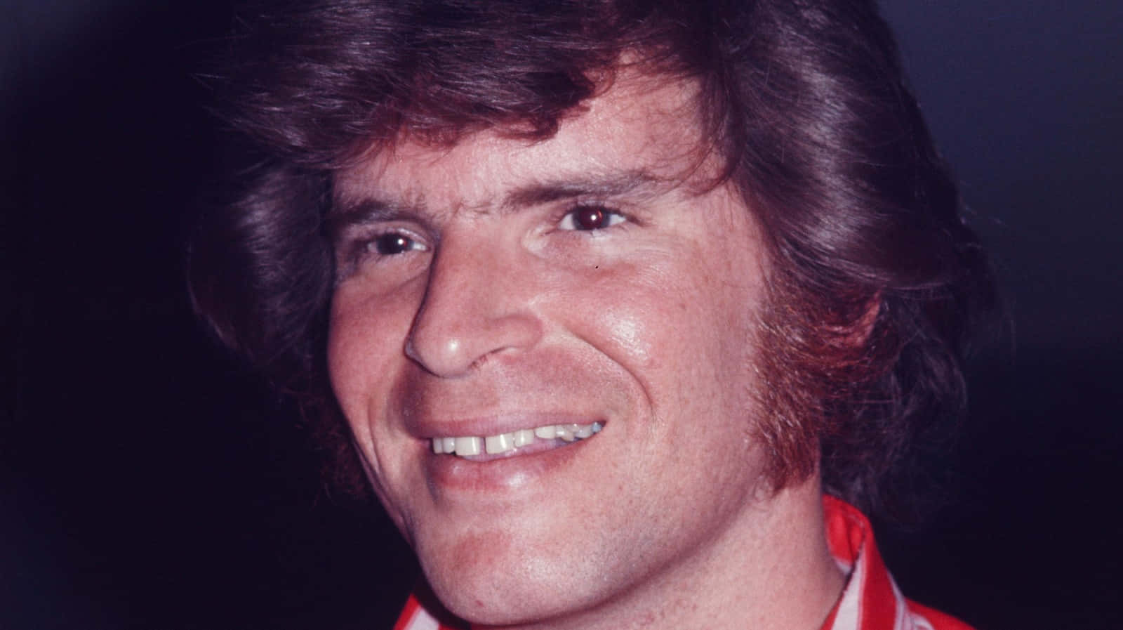 John Fogerty Smiling Portrait1970s Wallpaper