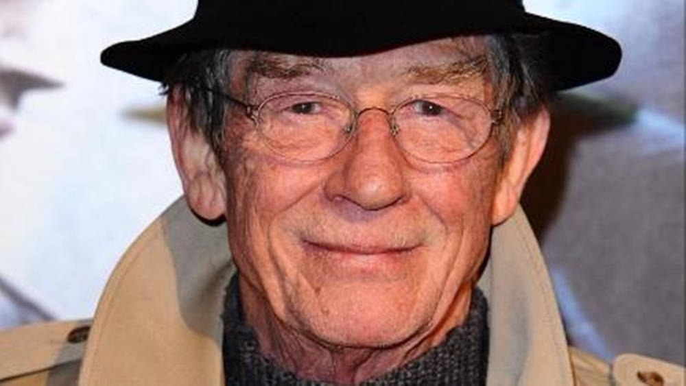 John Hurt Smiling Glasses And Hat Wallpaper