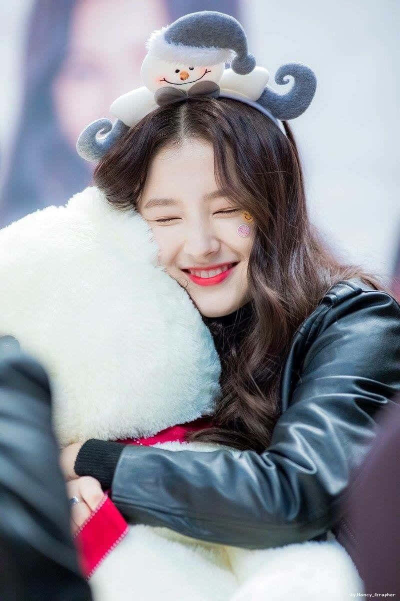 Joyful Hug With Plush Toyand Snowman Hat Wallpaper