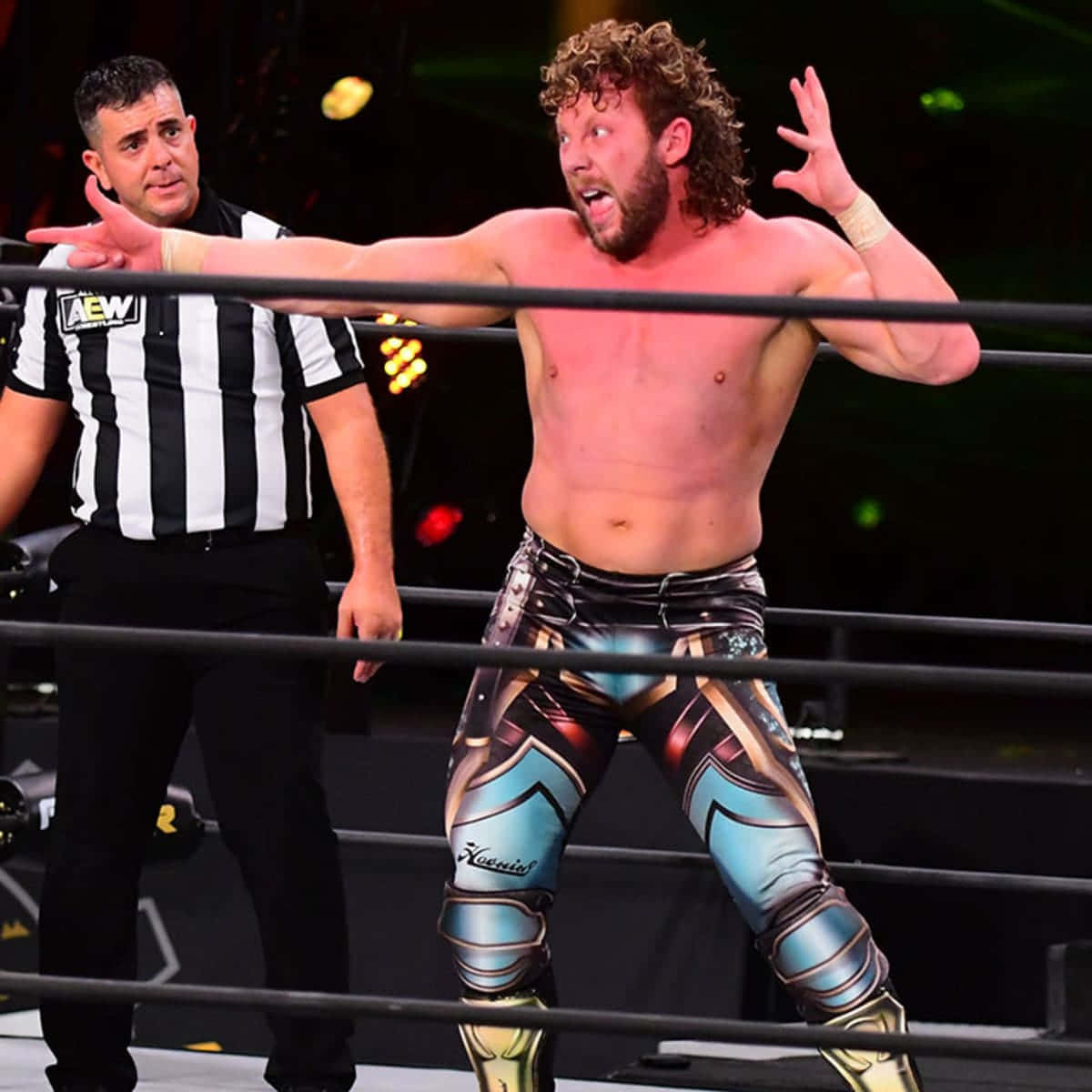 Kenny Omega, The Renowned Canadian Pro Wrestler, In A Pose With Referee Wallpaper