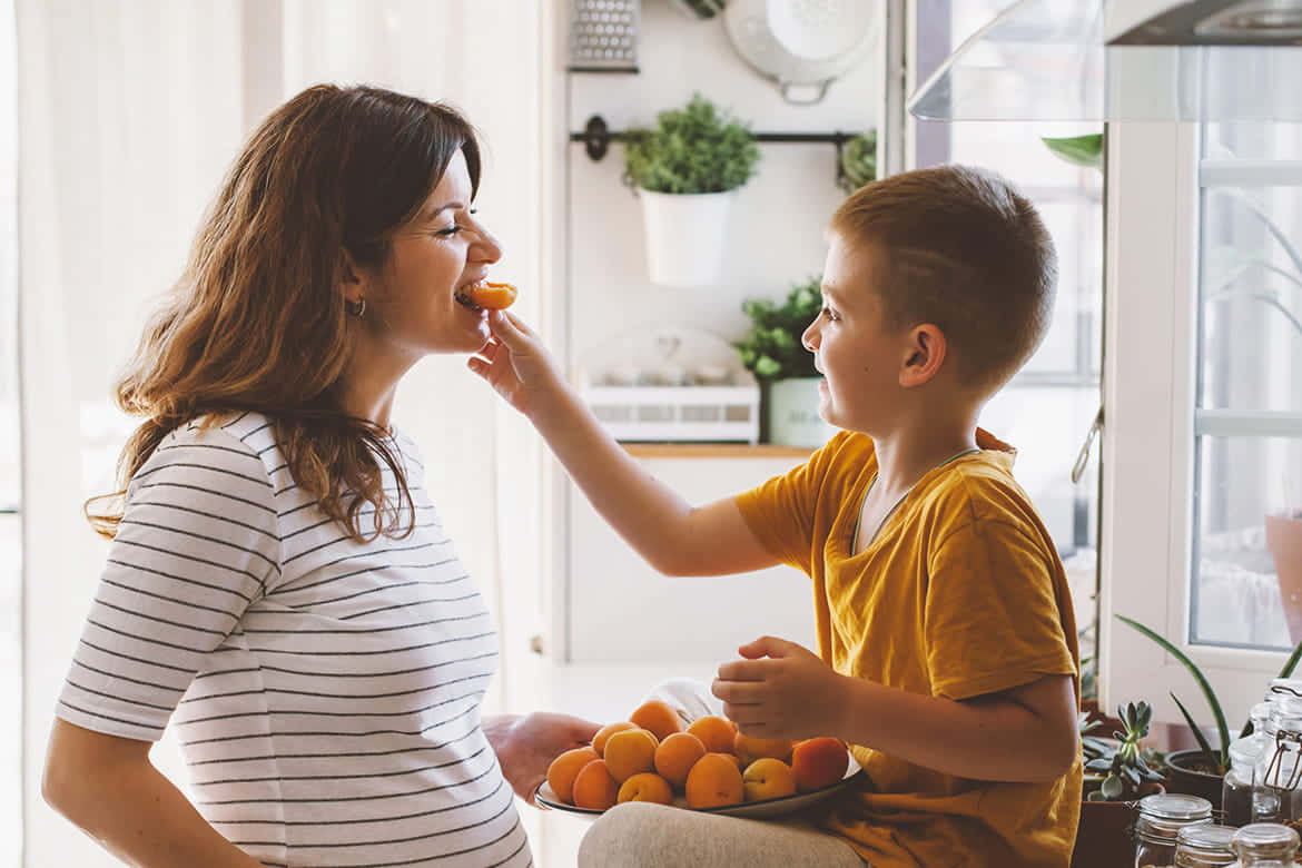 Kid Feeding Nauseous Pregnant Woman Wallpaper