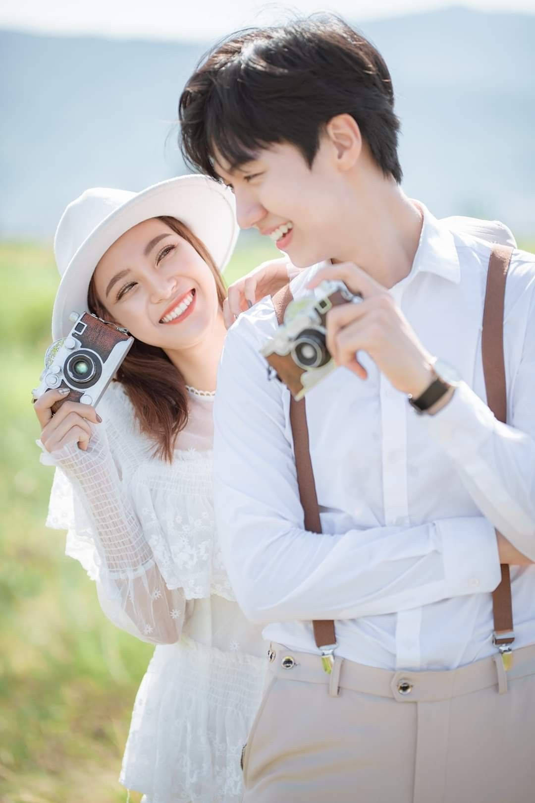 Korean Couple Holding Cameras Wallpaper