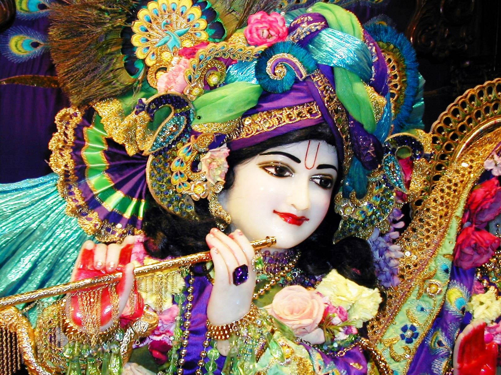 Krishna Bhagwan Statue With Colorful Clothes Wallpaper