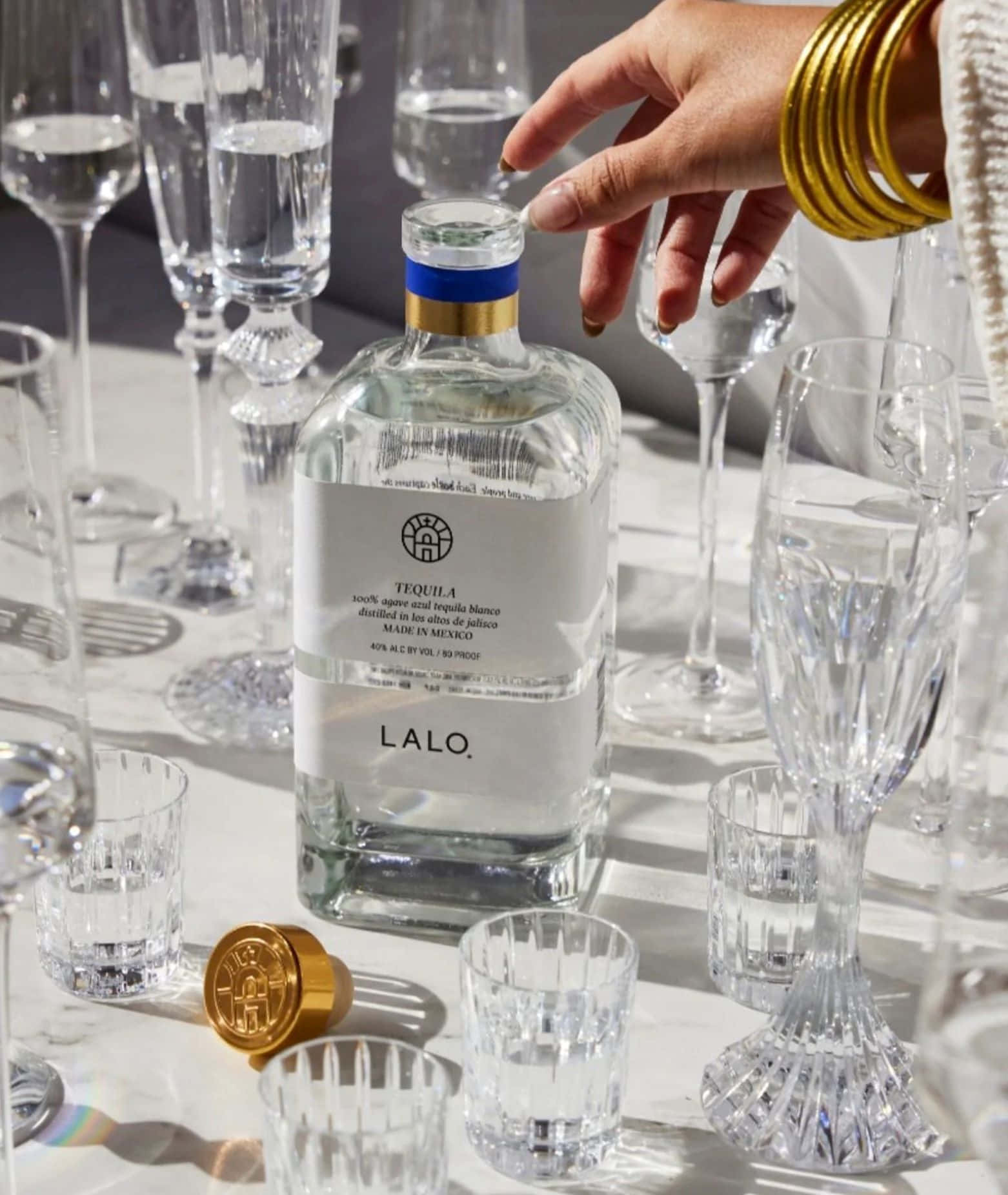 Lalo Tequila Bottle Among Crystal Glasses Wallpaper