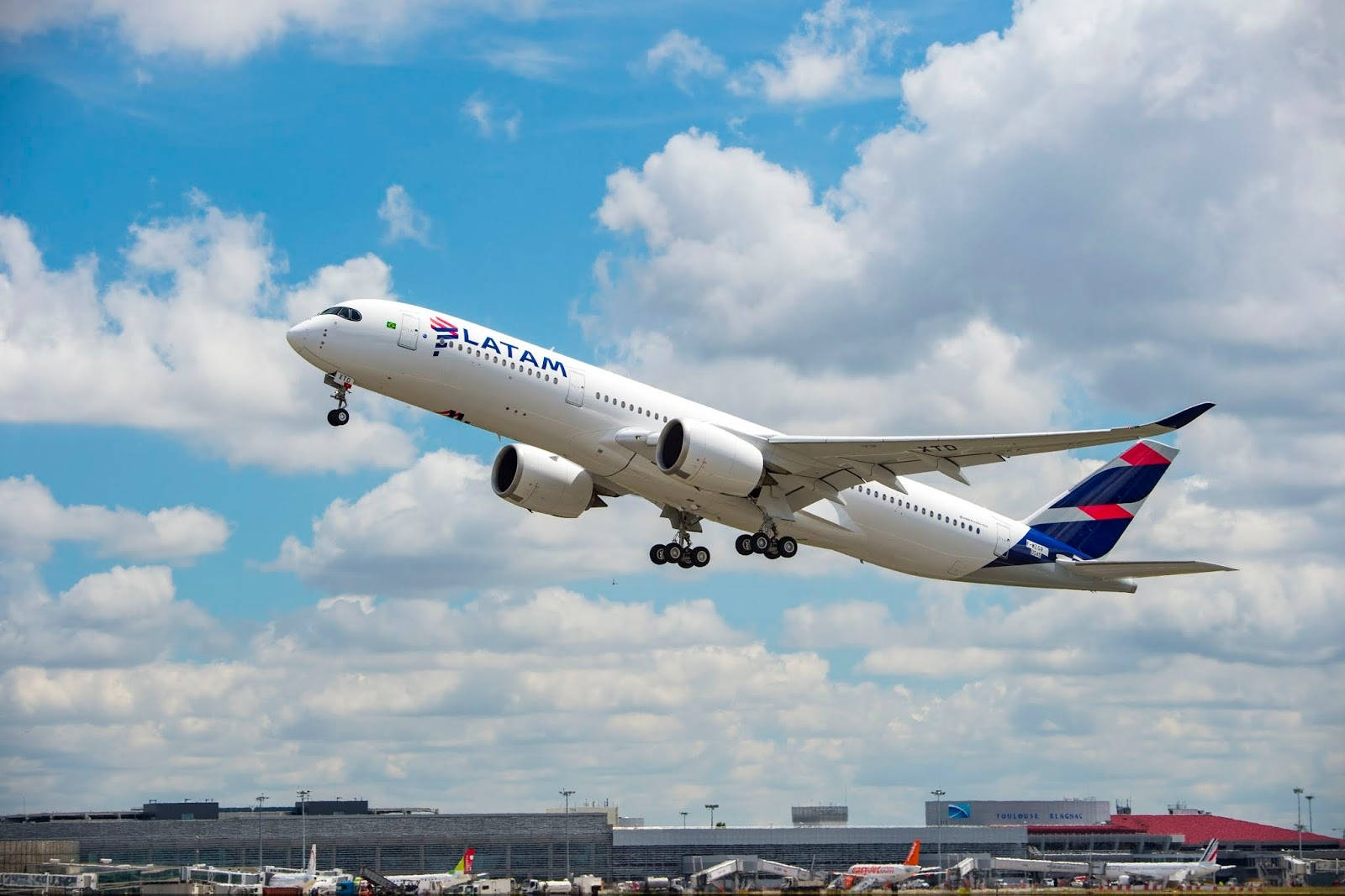 Latam Airlines Plane Ascending Over Cloudy Sky Wallpaper