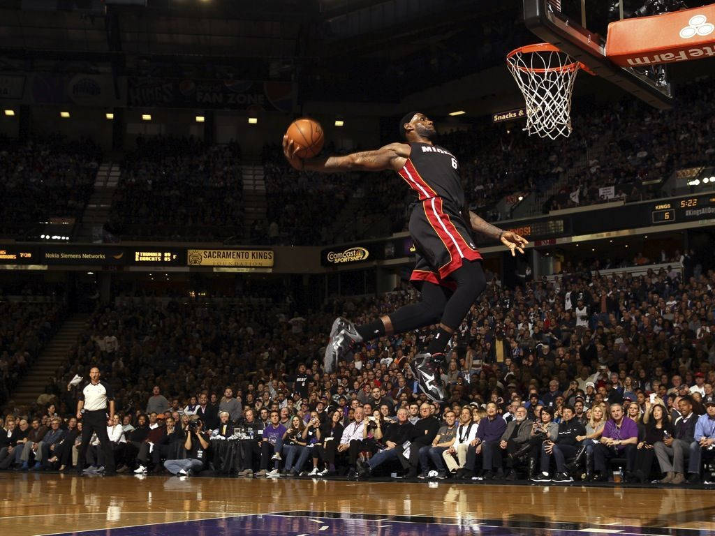 Lebron James Dominating With A Slam Dunk In An Iconic Miami Heat Jersey Wallpaper