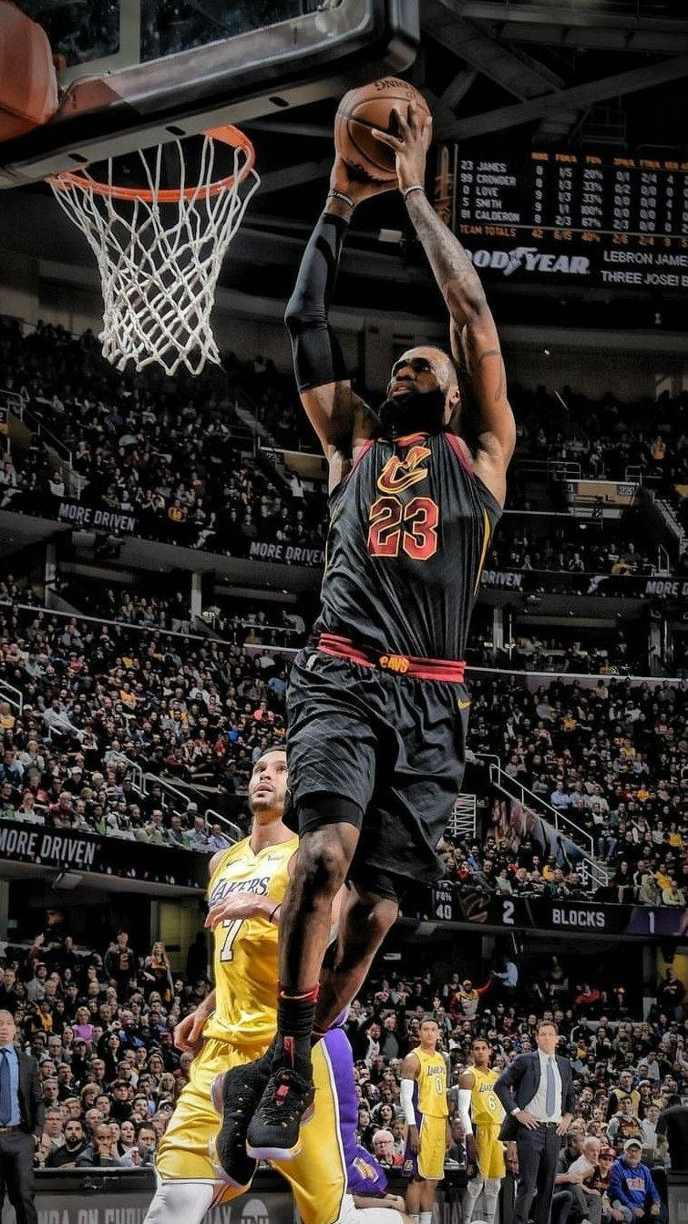 Lebron James In His Cavs Jersey Slam Dunking Wallpaper