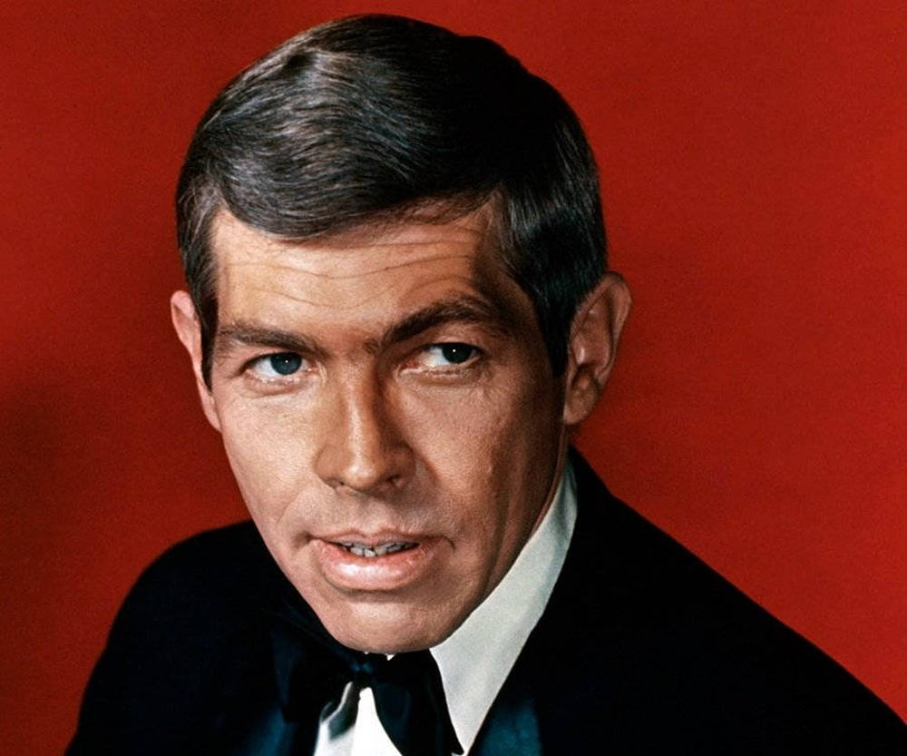 Legendary Actor James Coburn In A Still From 'in Like Flint' Wallpaper