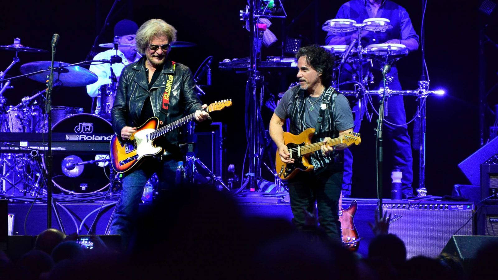 Legendary Duo Daryl Hall And John Oates Performing At A Concert Wallpaper