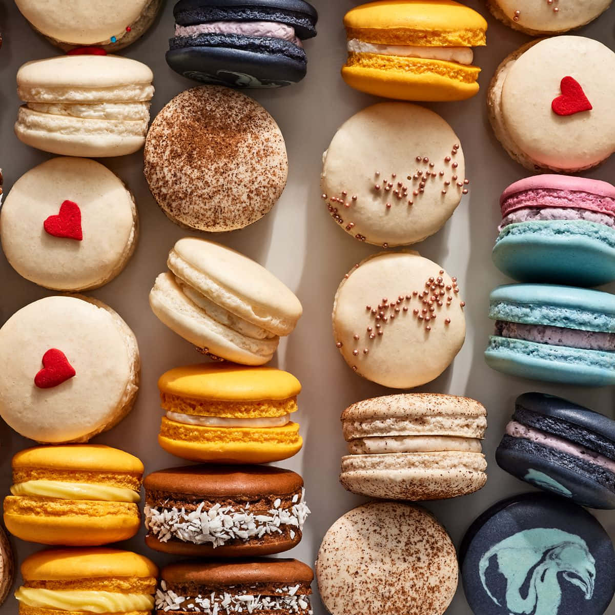 Love For French Macarons: Colourful Dessert Arranged In A Heart Shape Wallpaper