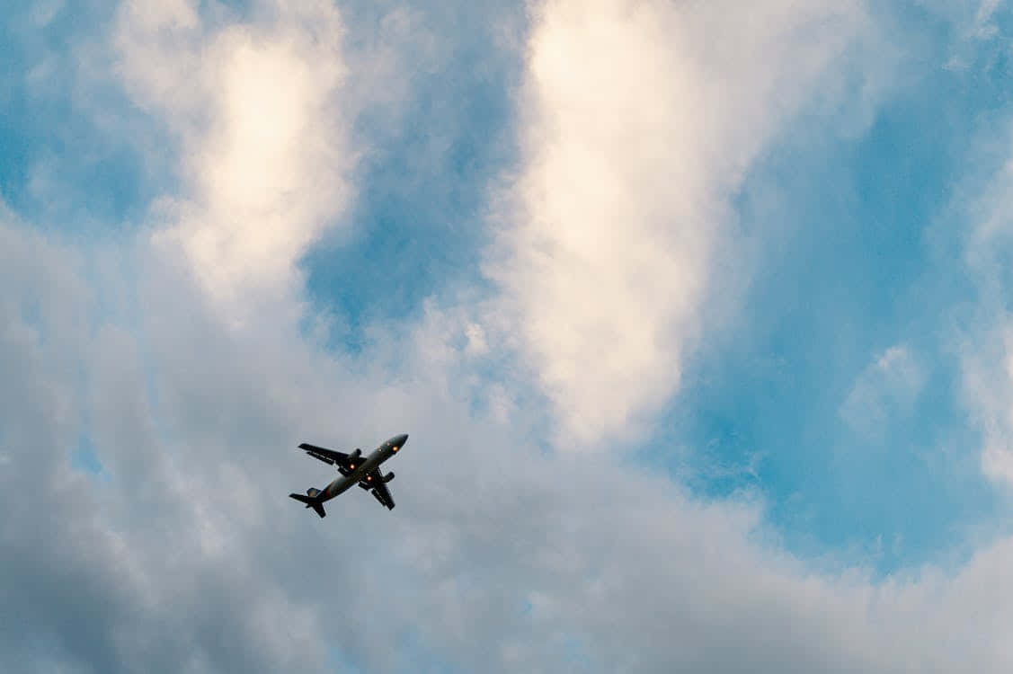 Low Angle Of Distant Small Airplane Wallpaper