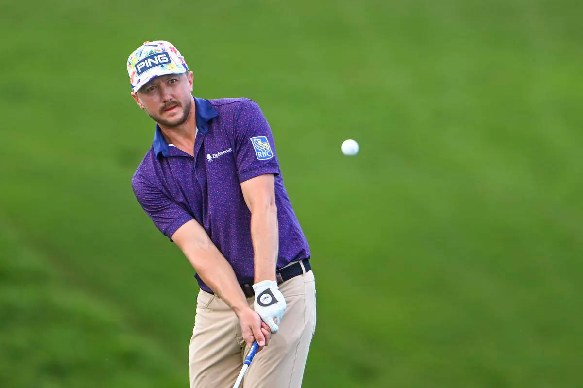 Mackenzie Hughes Looking At Golf Ball Wallpaper