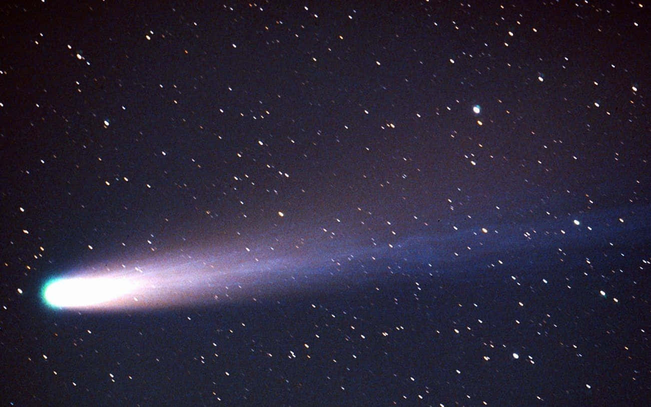 Majestic Comet Illuminating The Night Sky Wallpaper