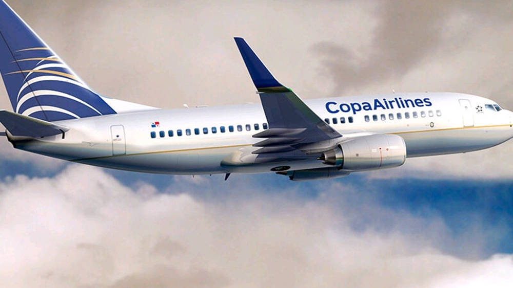 Majestic Copa Airlines Plane Soaring Through The Cloudy Sky Wallpaper