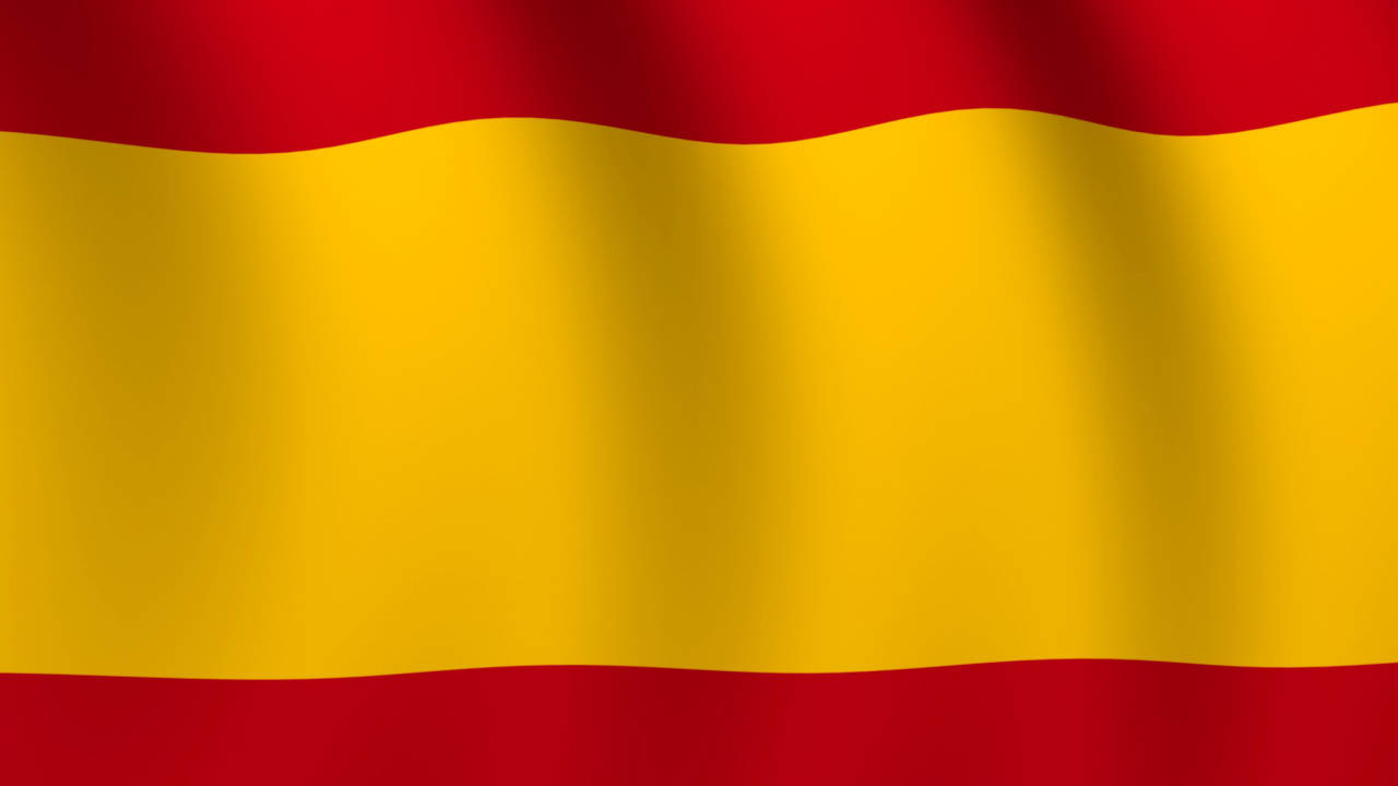 Majestic Flag Of Spain Fluttering In The Wind Wallpaper