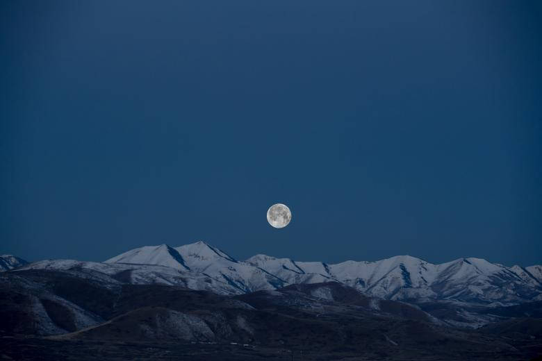 Majestic Full Moon Shining In The Night Sky Wallpaper