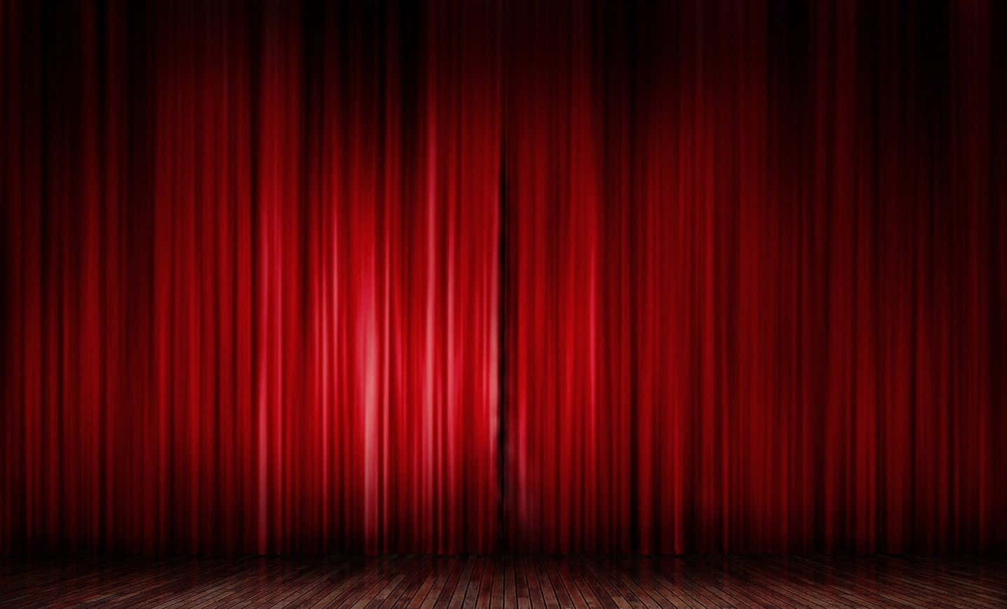 Majestic Red Curtains Of A Closed Theatre Stage Wallpaper