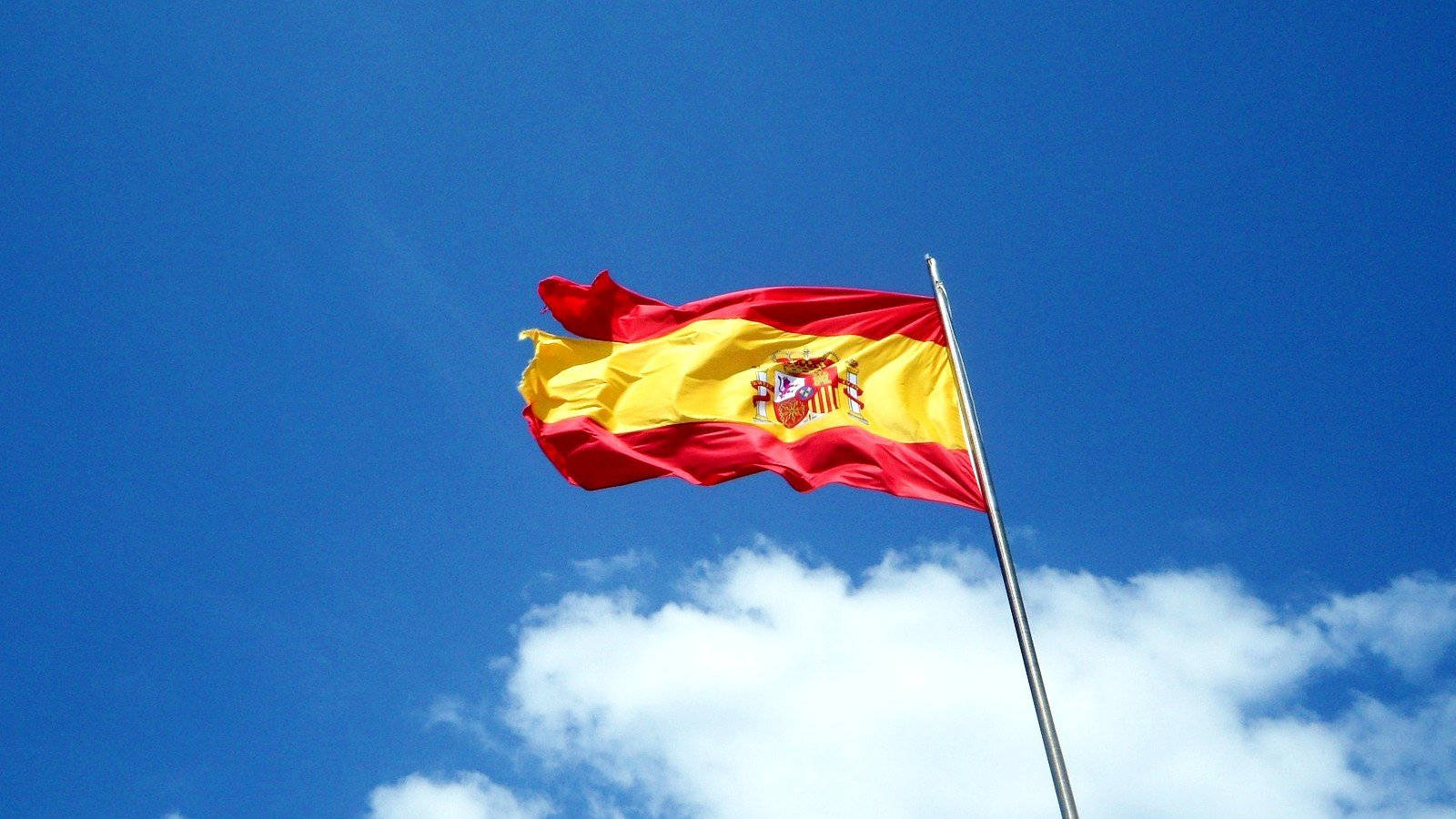 Majestic Spanish Flag In Mid-air Wallpaper