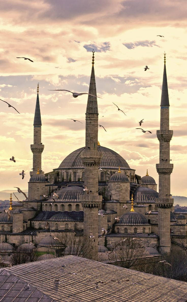 Majestic Spires Of Hagia Sophia Against A Sunset Sky Wallpaper