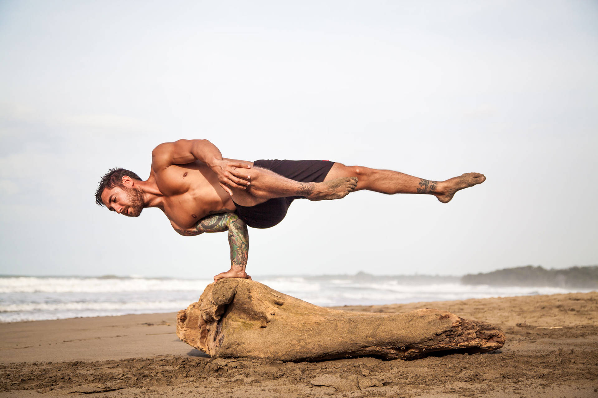 Download free Man In Extreme Yoga Stance Wallpaper 