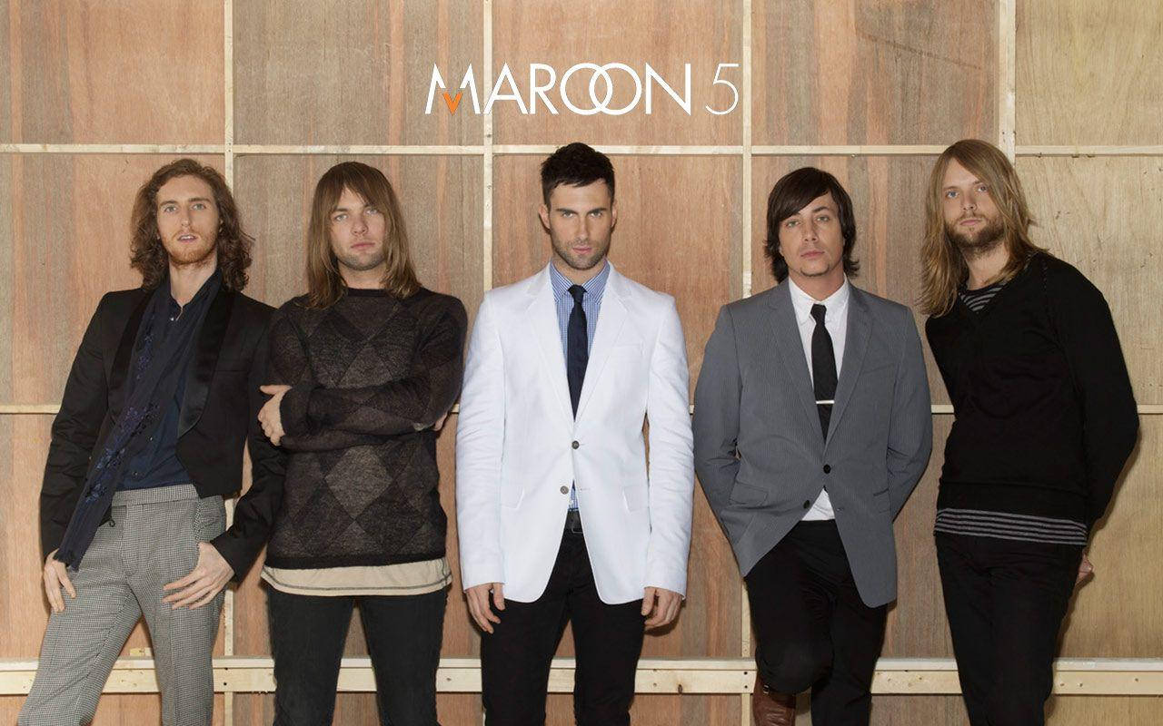 Maroon 5 Band Posing On A Wooden Background Wallpaper