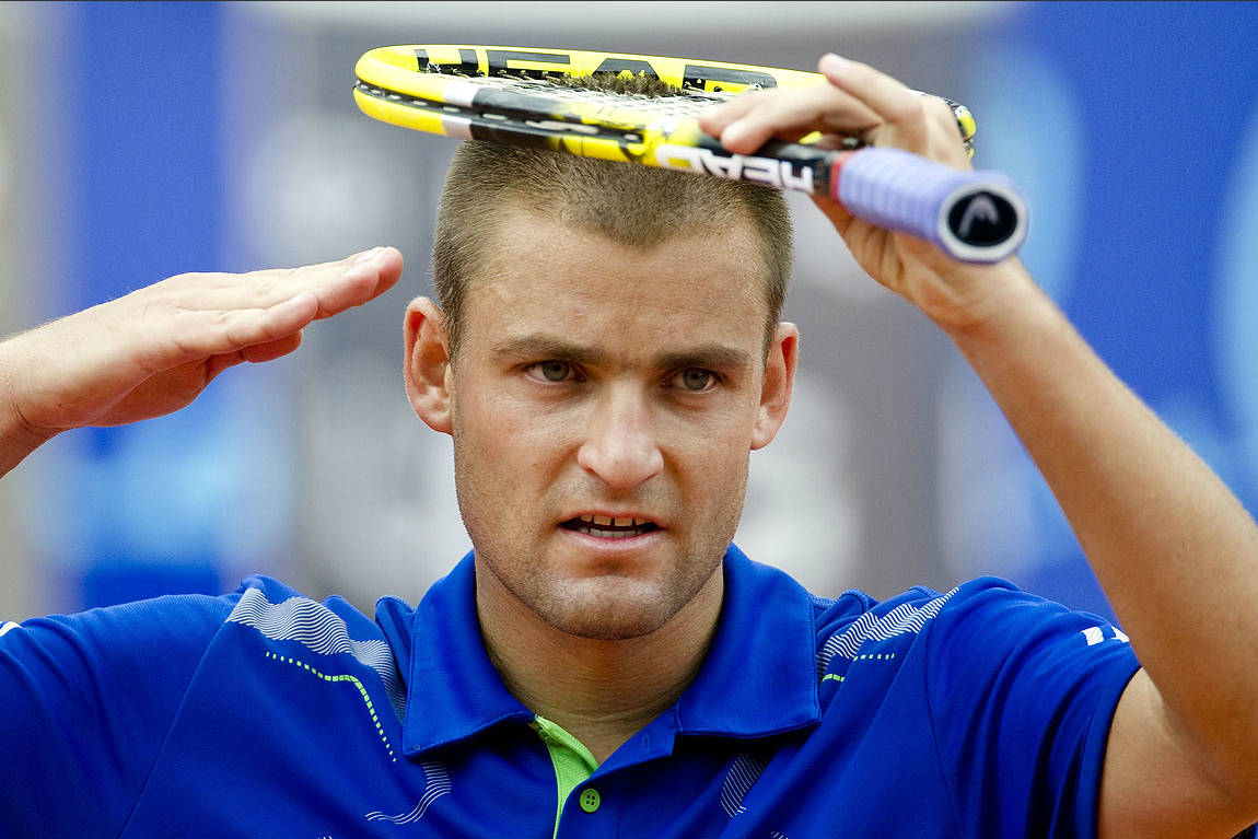 Mikhail Youzhny Doing His Signature Salute On A Tennis Court. Wallpaper