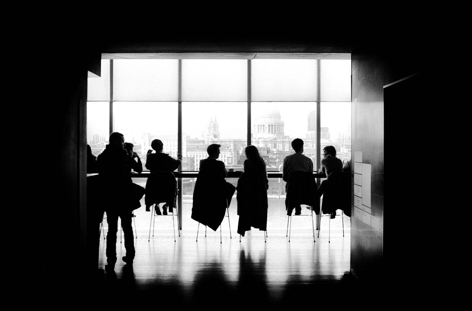 Monochrome Team Photo At Table Wallpaper