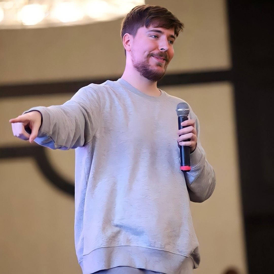 Mr Beast Pointing With Microphone Wallpaper