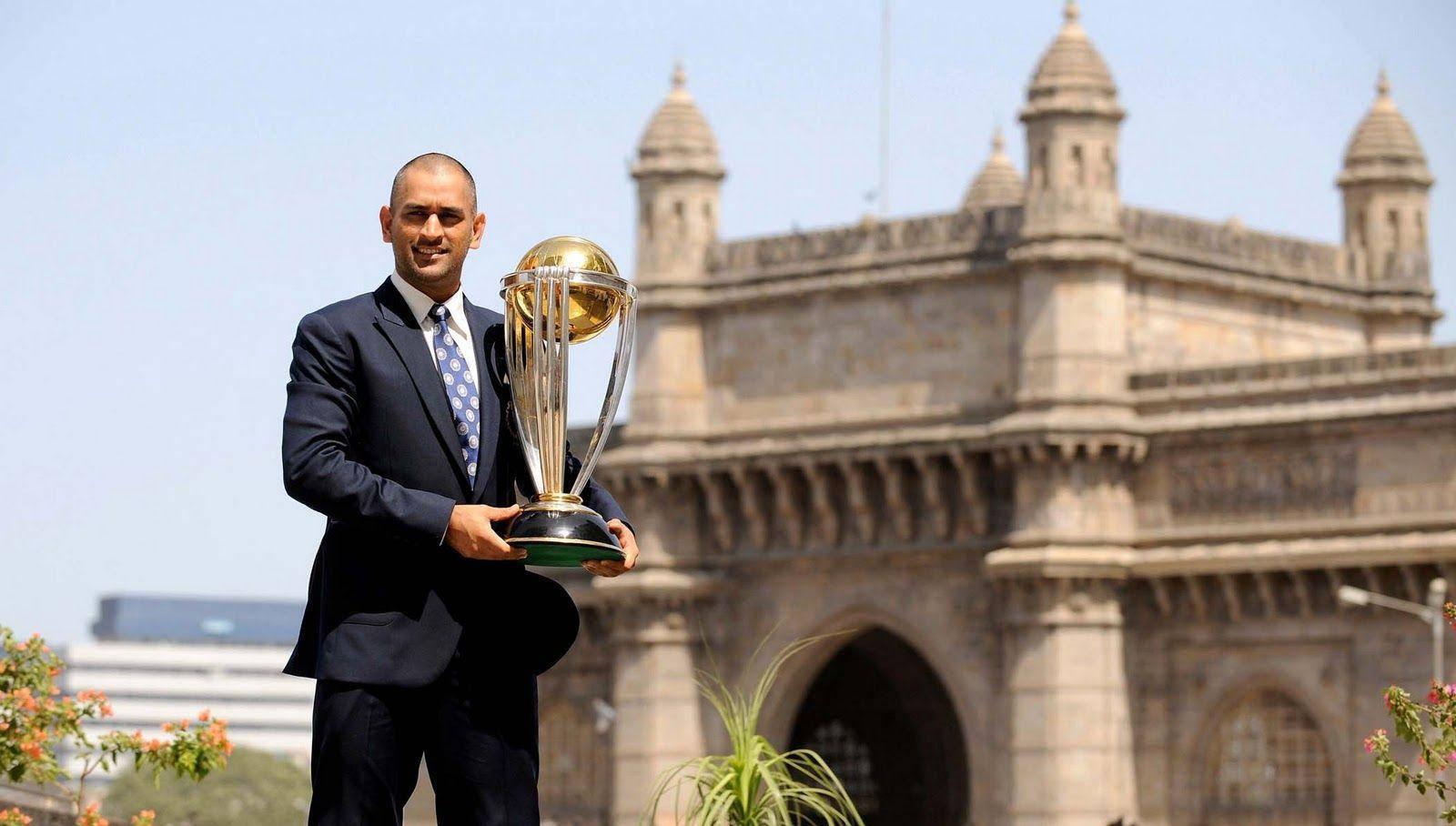 Ms Dhoni With Golden Championship Trophy Wallpaper