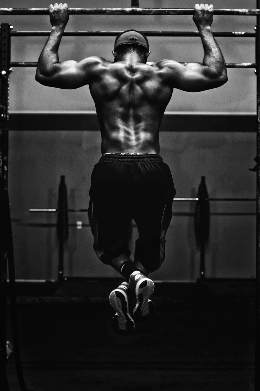 Muscular Man Performing Pull Up Workout Wallpaper