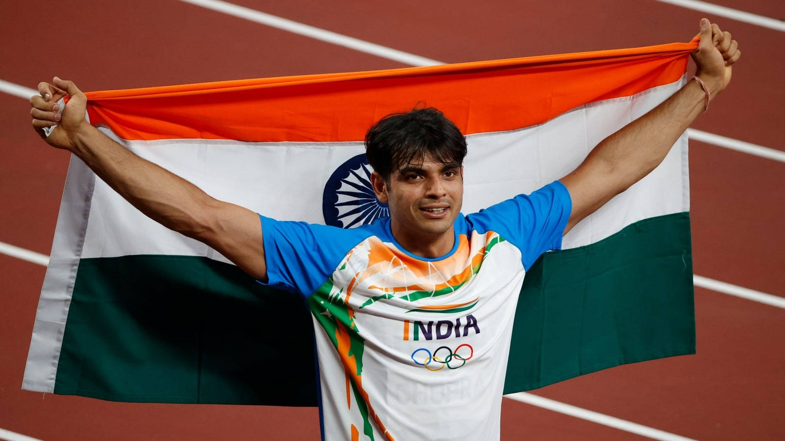 Neeraj Chopra With Indian Flag After His Victorious Olympic Win Wallpaper