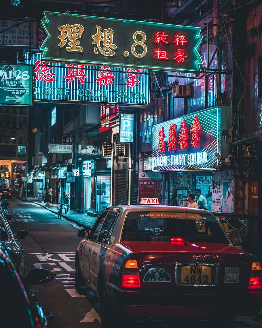 Neon Lit Urban Street At Night Wallpaper