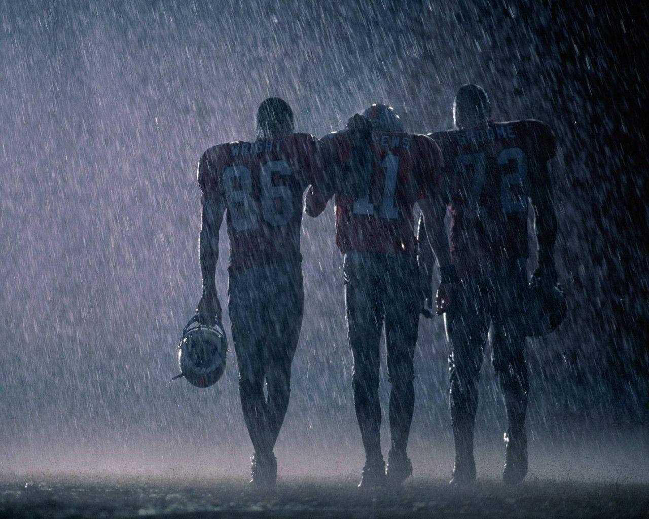 Nfl Football Players In The Rain Wallpaper