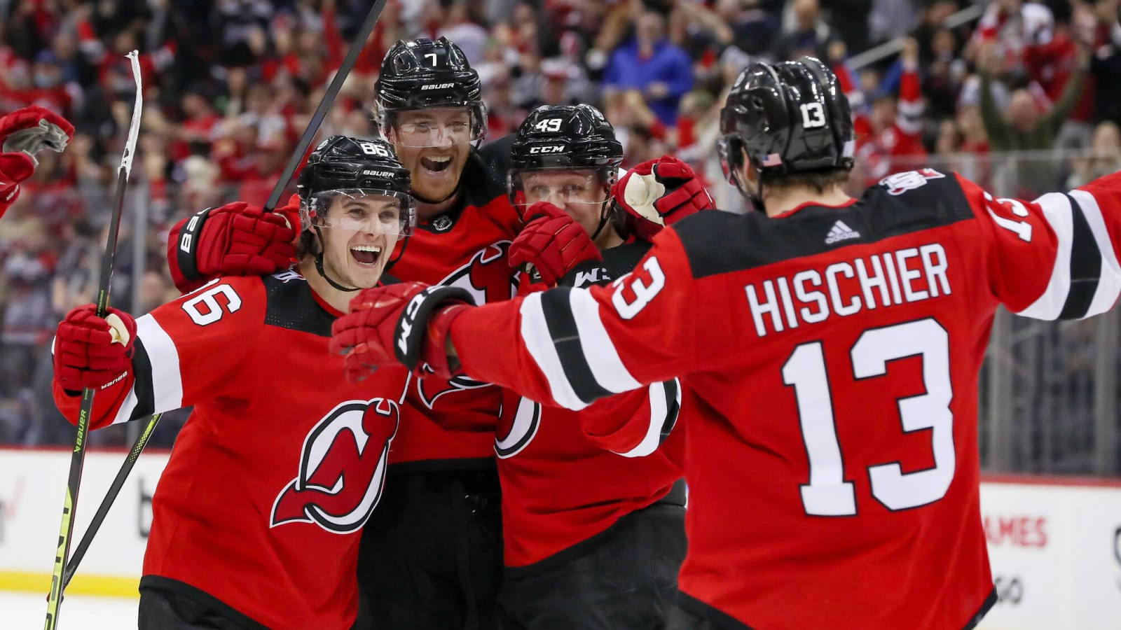 Nico Hischier Celebrating With Team On Ice Wallpaper