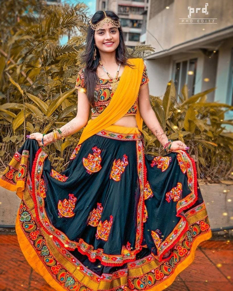 Nisha Guragain Adorning A Vibrant Yellow Traditional Gujarati Dress Wallpaper