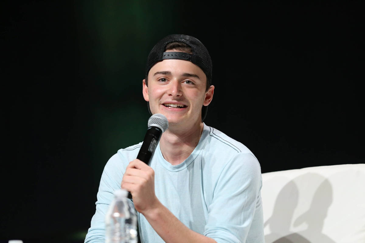 Noah Schnapp Holding Microphone Wallpaper