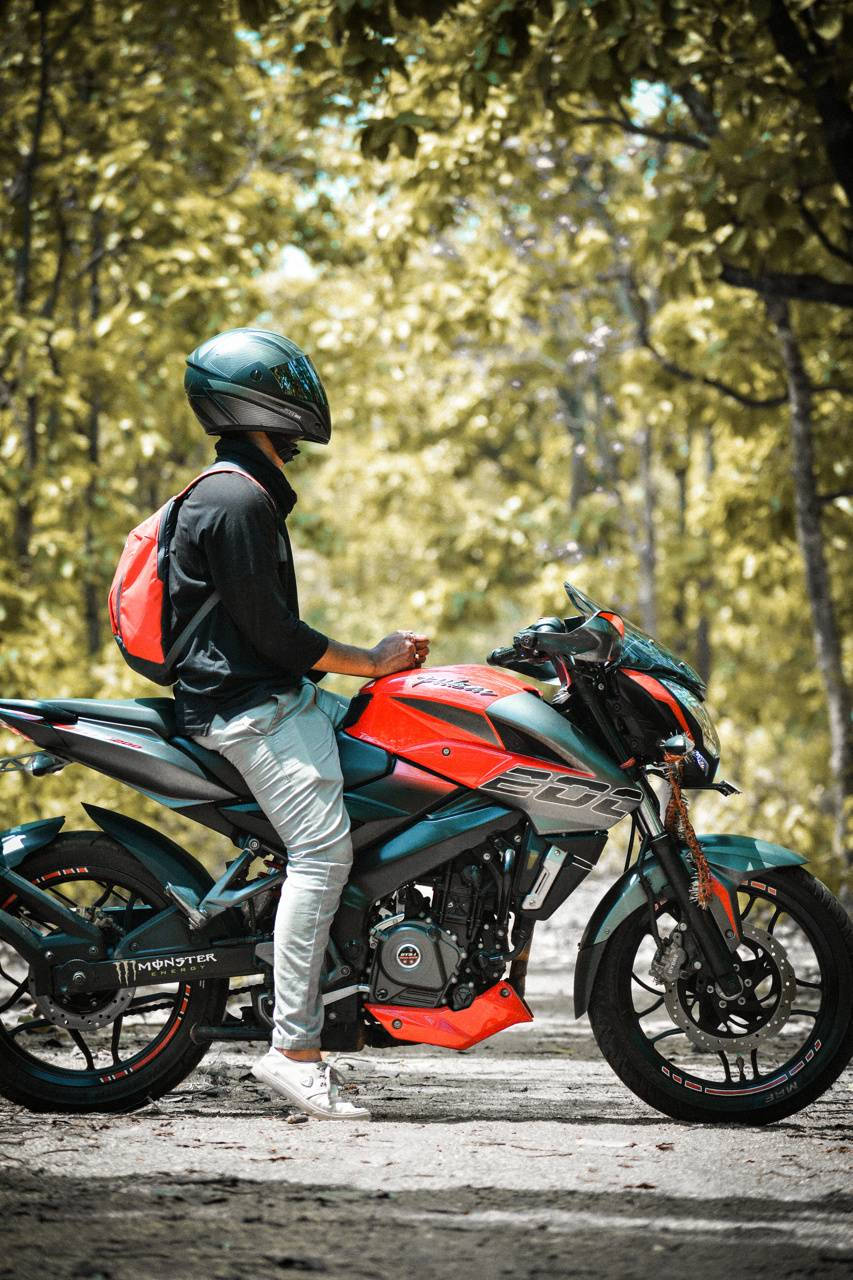 Ns 200 Motorcycle With Man In Forest Wallpaper