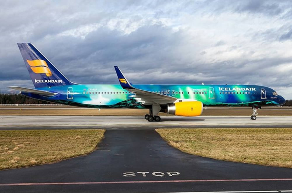 Ocean Blue Icelandair Airplane On Runway Wallpaper