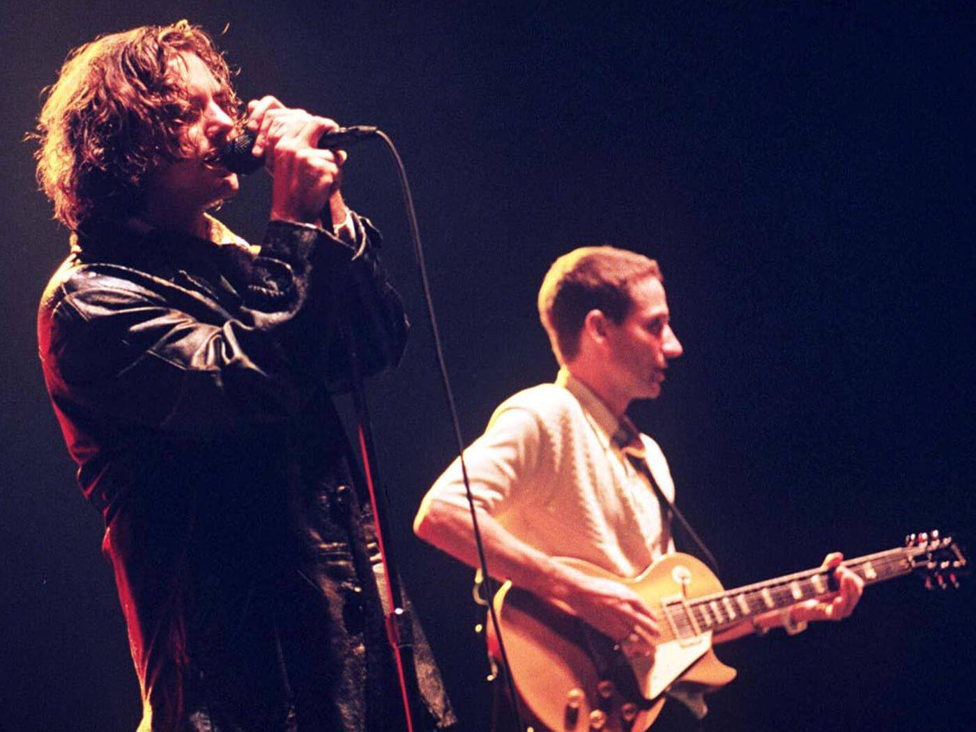 Pearl Jam Rock Band's Frontman Eddie Vedder Engrossed In Performance Wallpaper