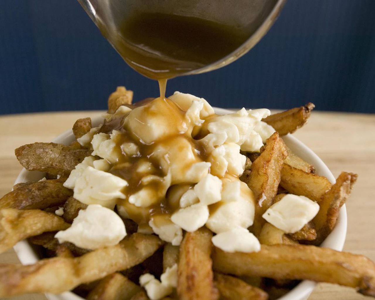 Pouring Hot Gravy To Poutine Wallpaper