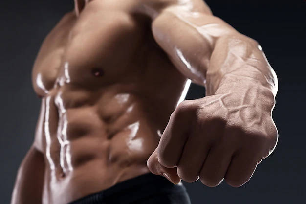 Powerful Bodybuilder Striking A Pose In High Definition Wallpaper