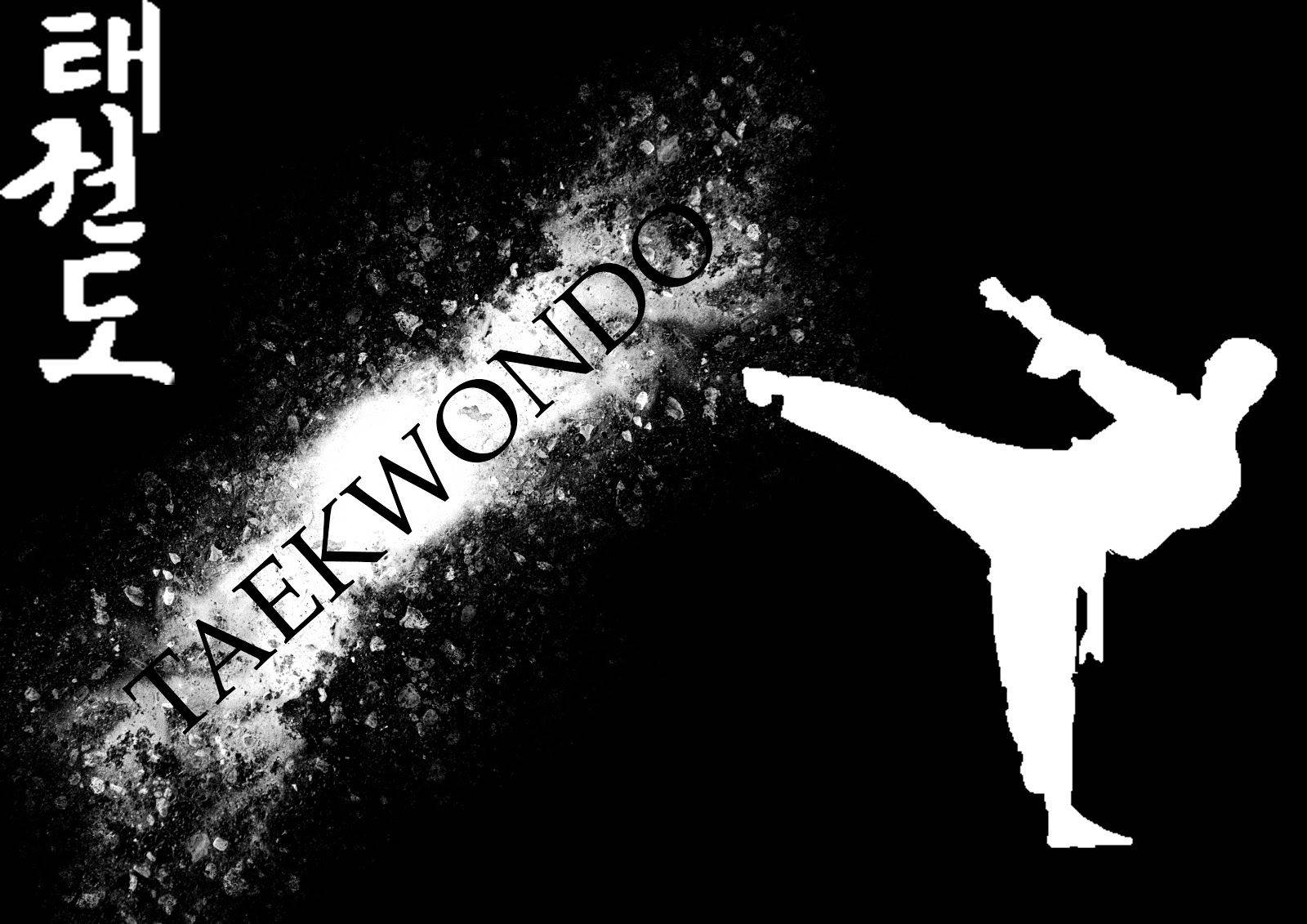 Powerful Taekwondo Martial Artist In Action Wallpaper